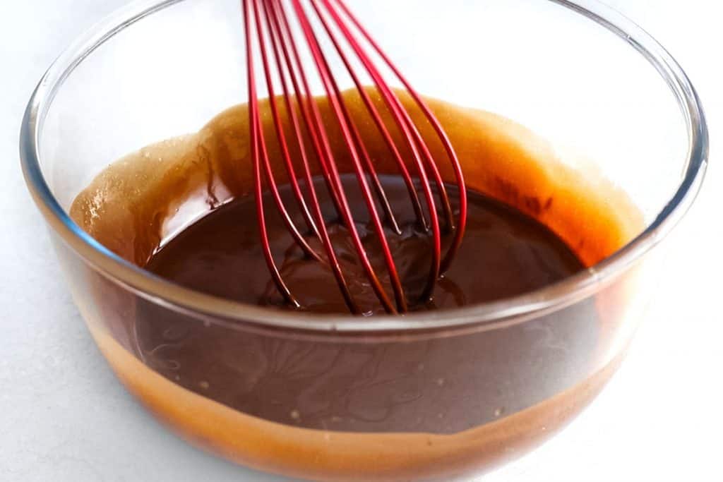The chocolate mixture being mixed with a whisk