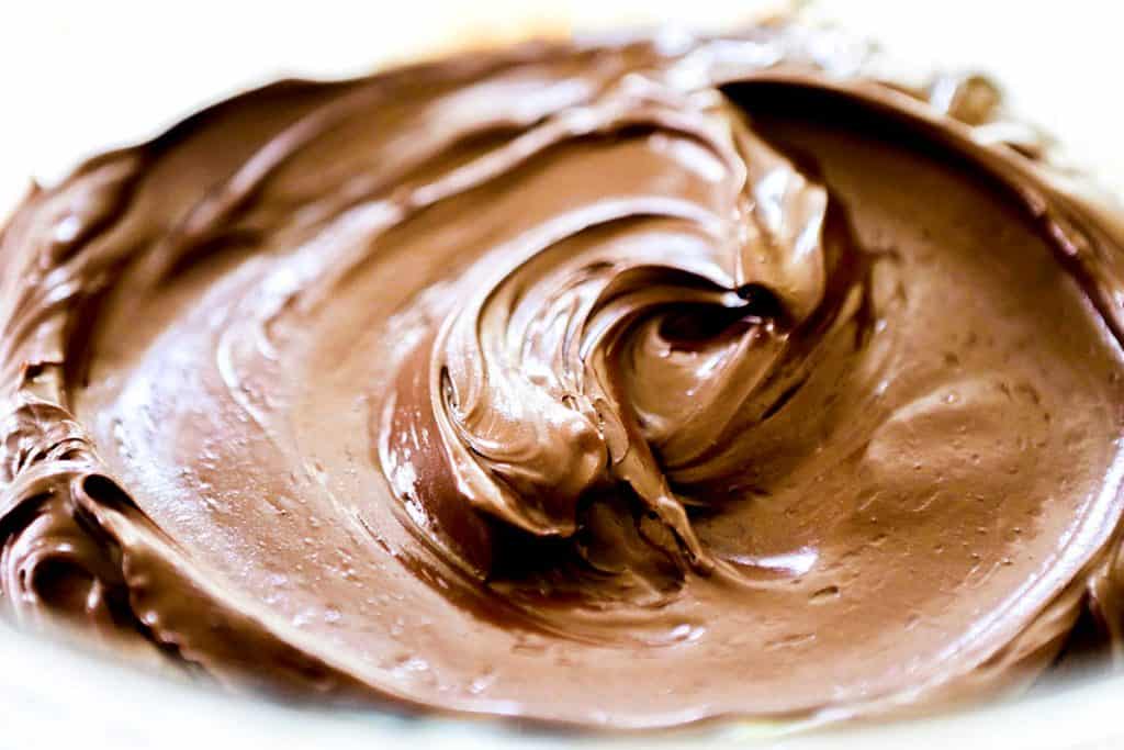 Chocolate Ganache Frosting swirled in a bowl ready to serve
