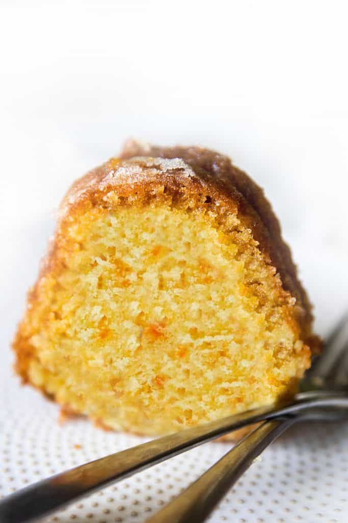 A slice of Orange Bundt cake on a plate with two forks