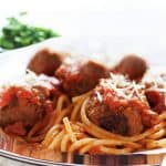 a close up of Spaghetti and Meatballs on a plate with a fork