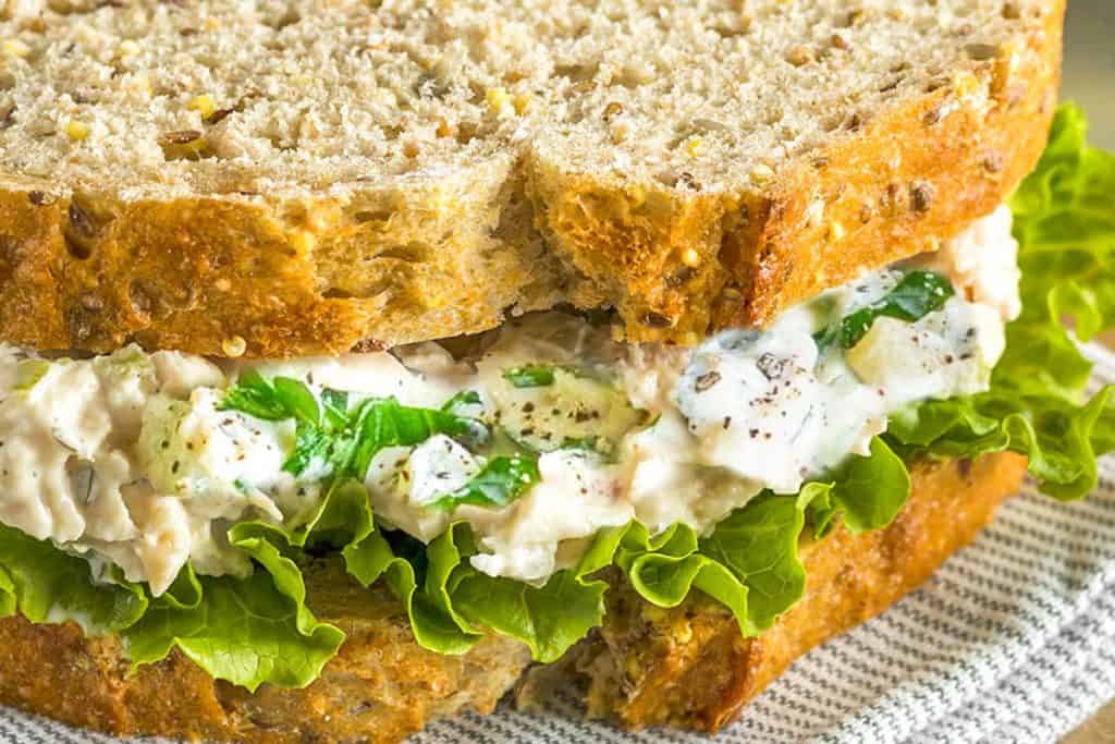 a close up of A tuna salad sandwich with lettuce