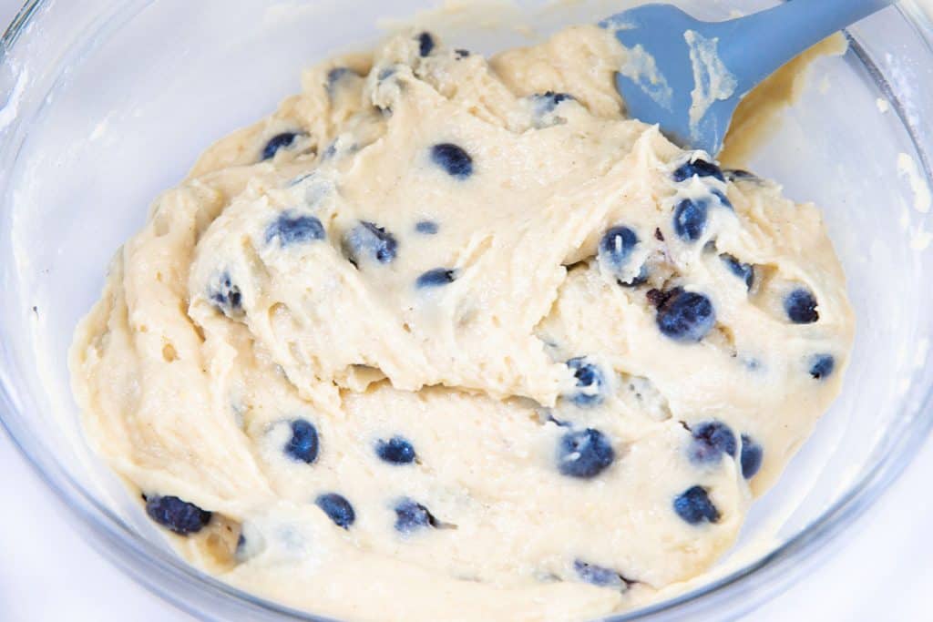 the thick batter mixed in a bowl with the blueberries mixed in