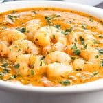 Shrimp Coconut Curry in a serving dish with rice in the background