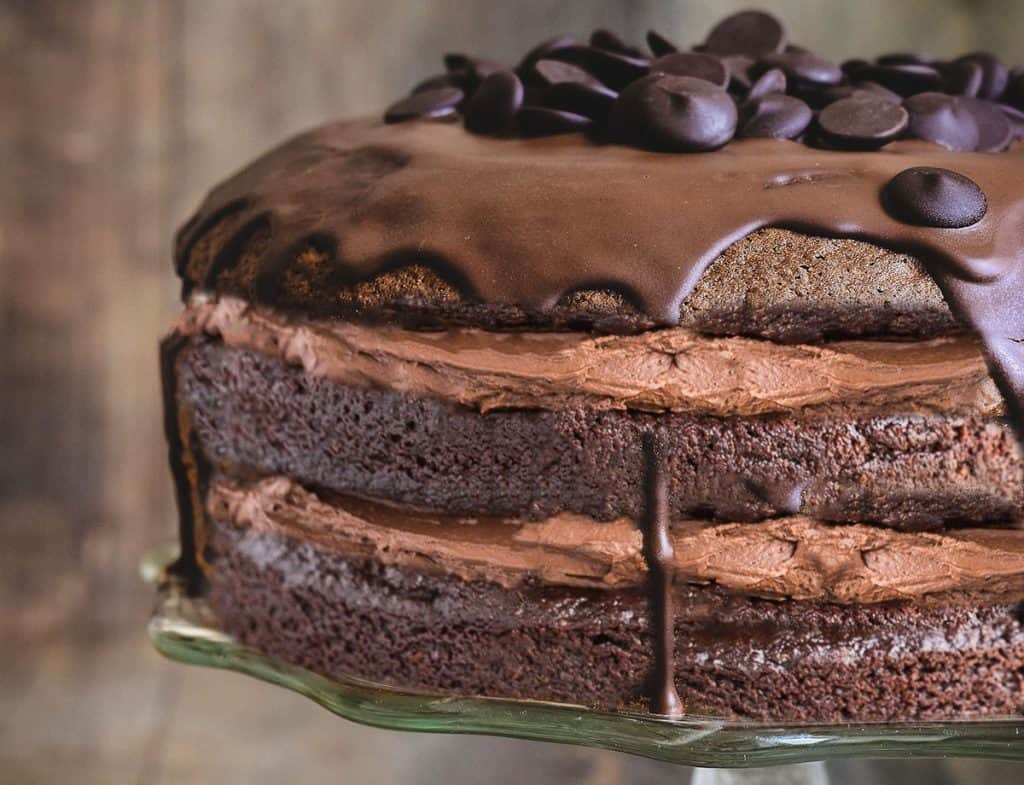 a close up of Chocolate cake with chocolate buttercream with a rustic background.