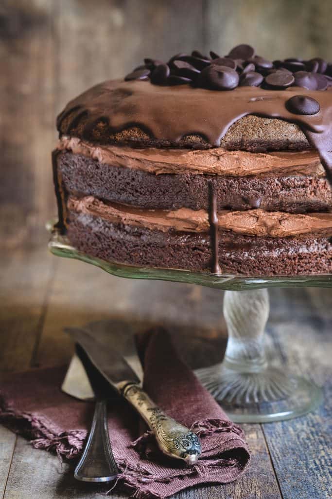 Chocolate cake with chocolate buttercream with a rustic background.