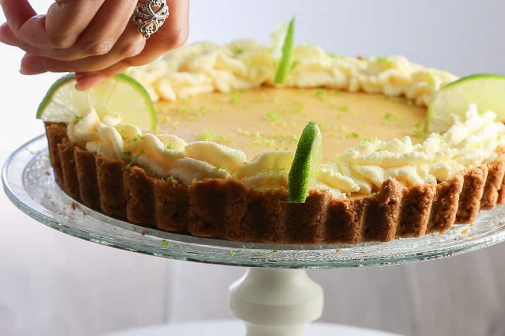 lime slices being placed on the pie