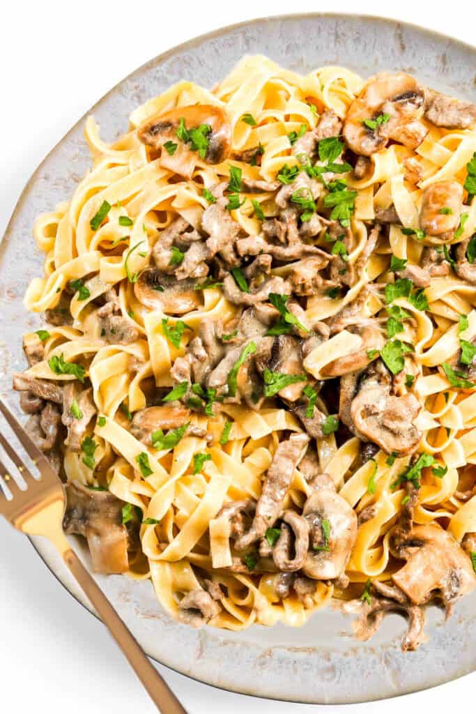 the Easy Beef Stroganoff served over egg noodles on a serving platter.