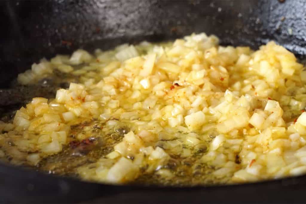 onions cooking in a pan with butter