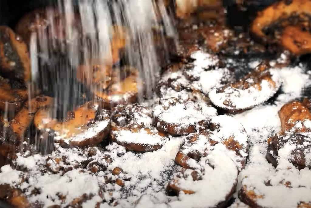 flour being poured into the pan with the mushroom mixture