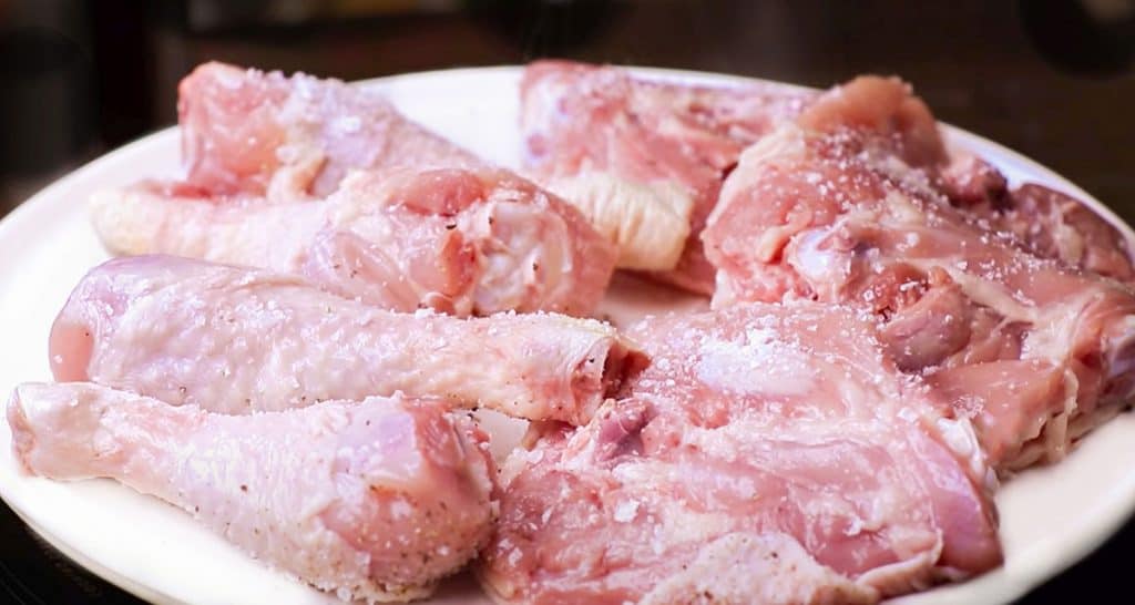 raw chicken seasoned with salt and pepper