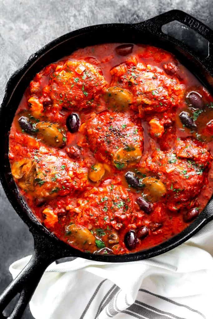 an overhead shot of chicken cacciatore in a pan