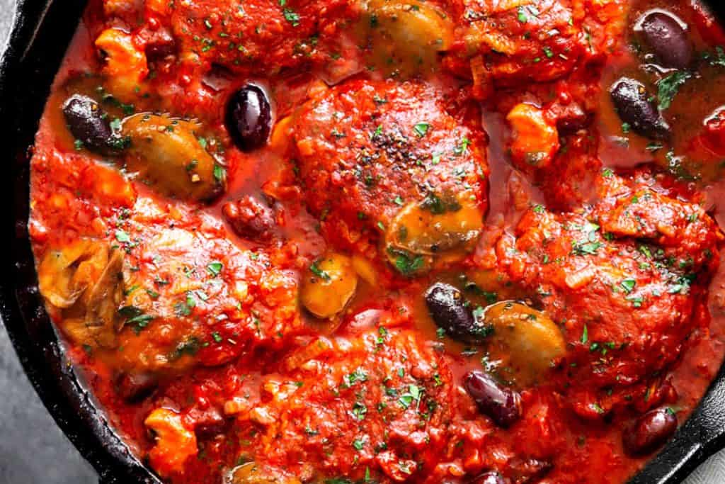 an overhead shot of chicken cacciatore in a pan