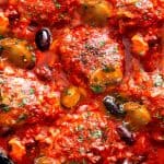 an overhead shot of chicken cacciatore in a pan