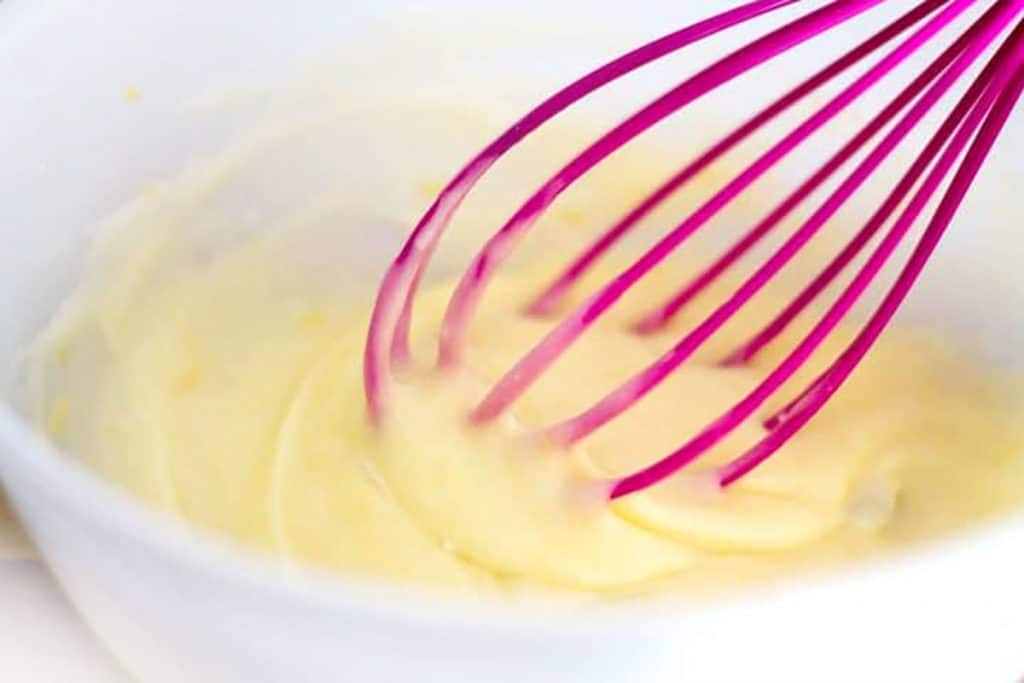 lemon glaze for the scones being mixed with a whisk