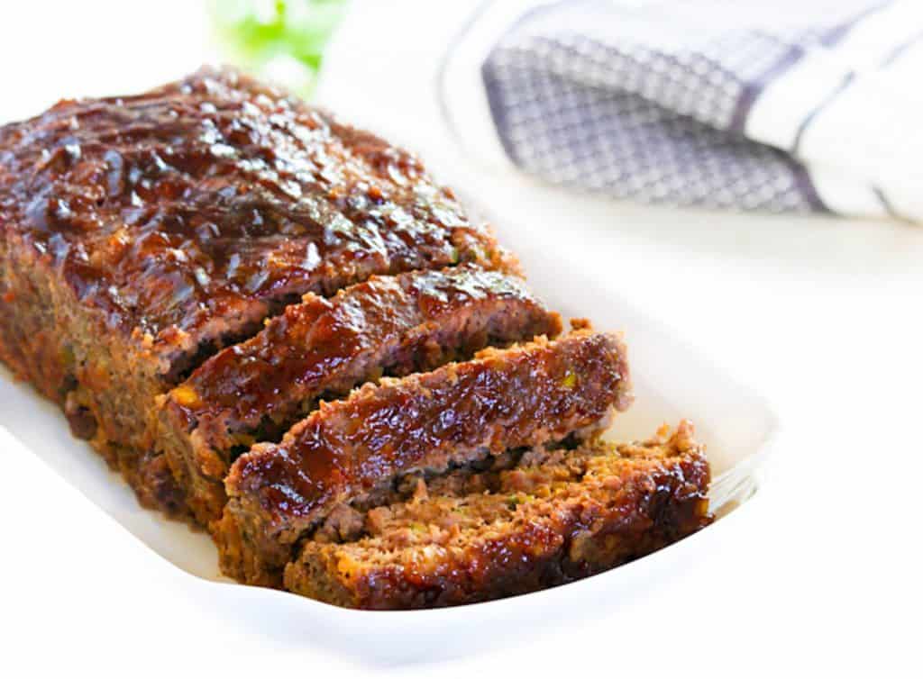 a sliced meatloaf on a serving dish