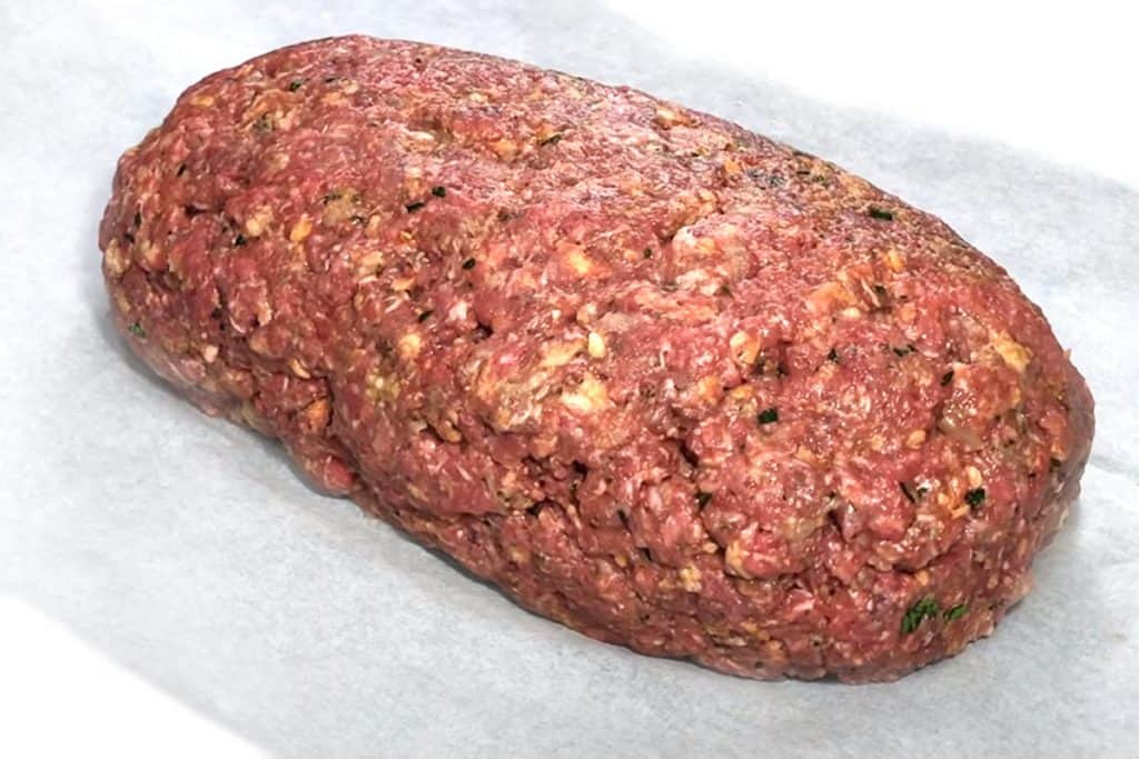 a raw meatloaf in a pan