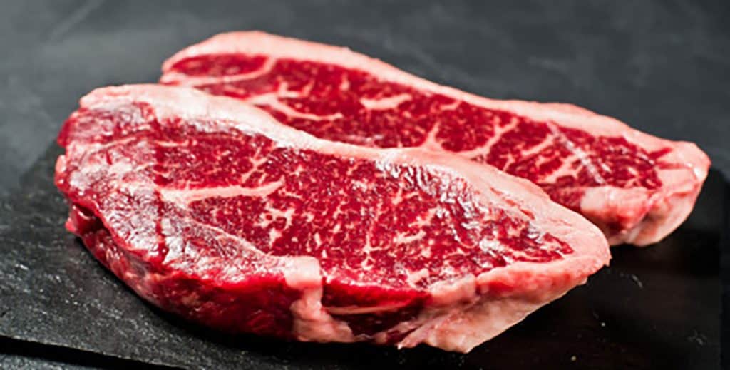 raw steak on a slate board