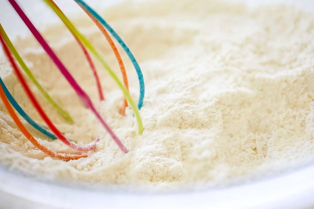 a whisk mixing the flour mixture