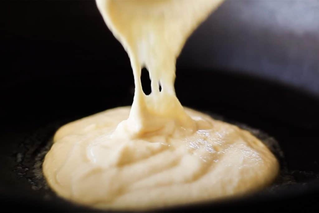 Pancake batter being added to a pan