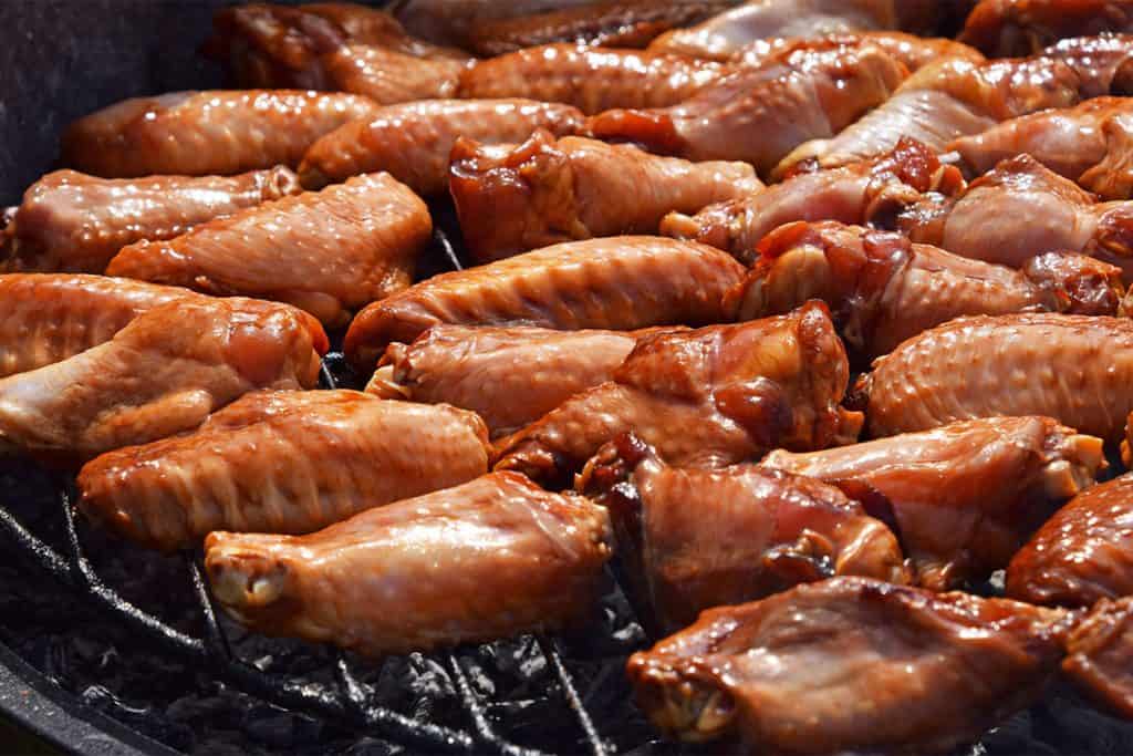 chicken wings cooking on a grill