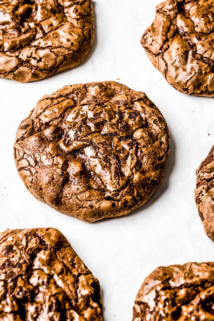 Brownie Cookies laid out on a pan with white baking paper