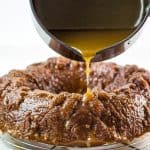a cake with caramel sauce being poured over it