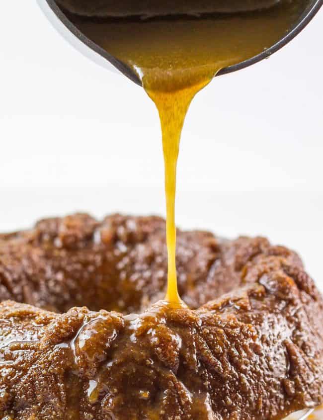 a cake with caramel sauce being poured over it