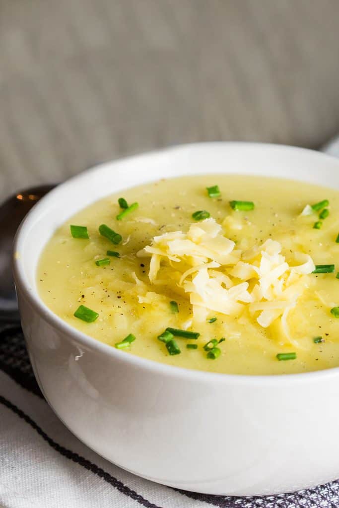 potato leek soup topped with chopped chives and grated cheddar