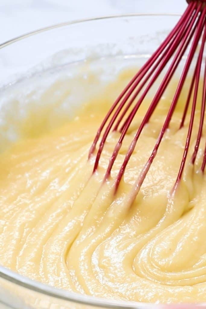 cake batter being mixed in a bowl