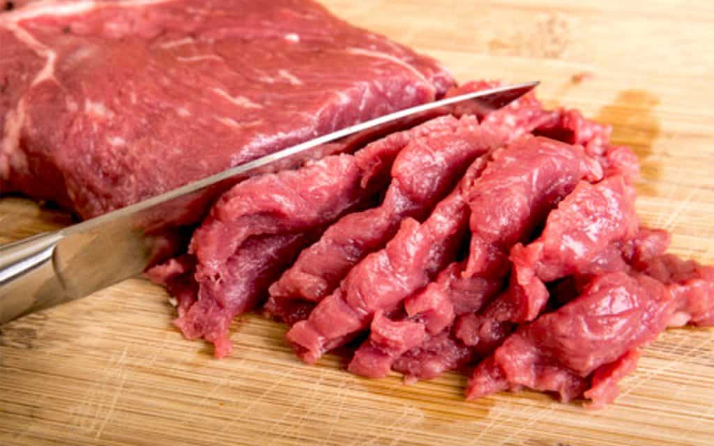 beef being cut into stips