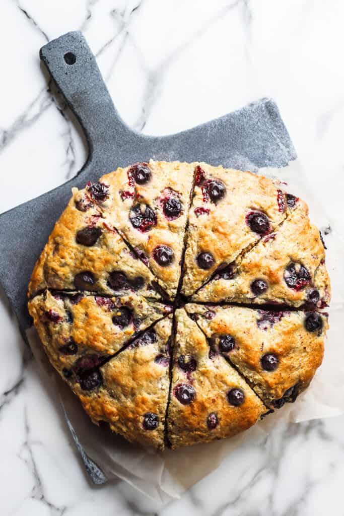 A batch of fresh blueberry scones sliced into wedges