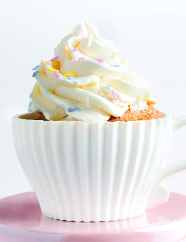a cupcake topped with a swirl of buttercream and decorated with sprinkles.