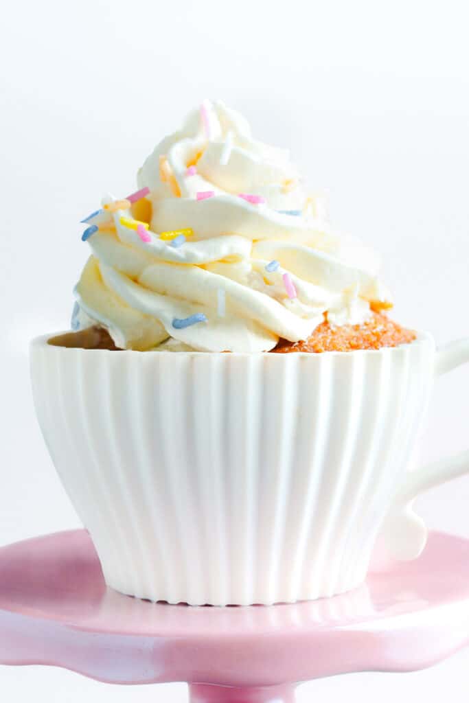 a cupcake topped with a swirl of buttercream and decorated with sprinkles.