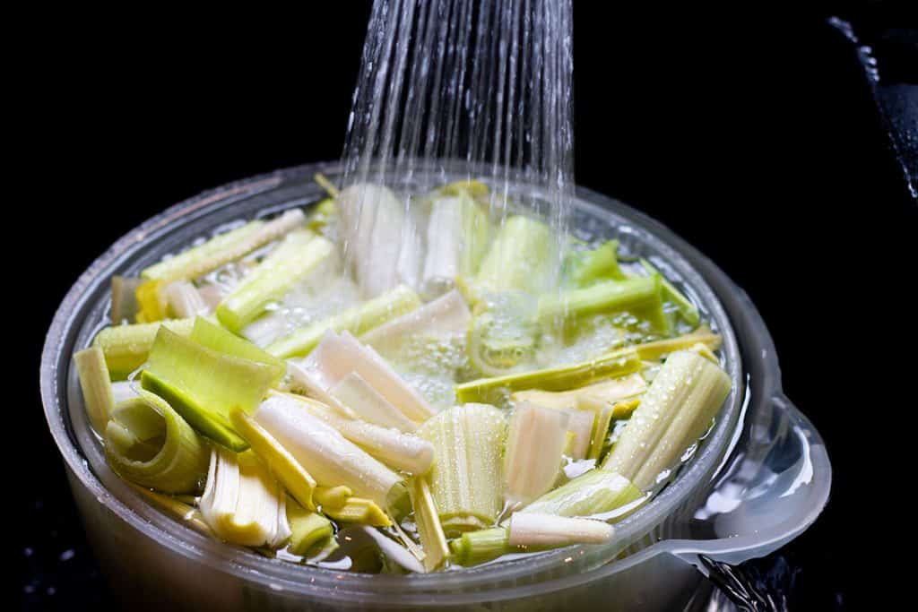 leeks being cleaned with water