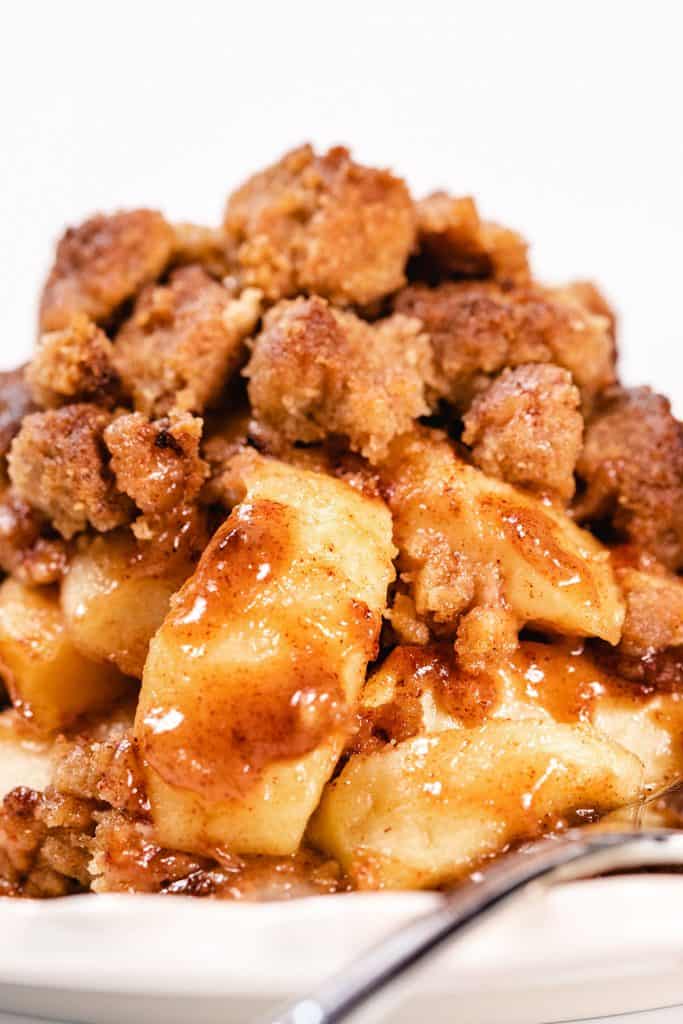 a dish piled high with baked Apples and crumb topping