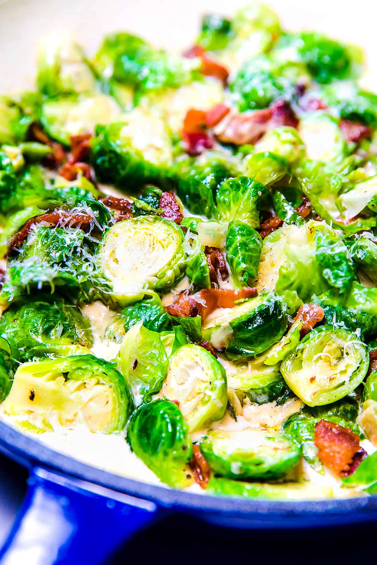 a pan with brussels sprouts and bacon in a cream sauce
