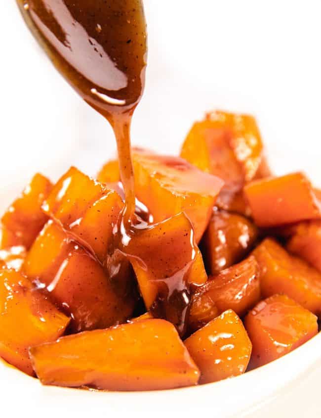 caramel sauce being spooned onto sweet potatoes