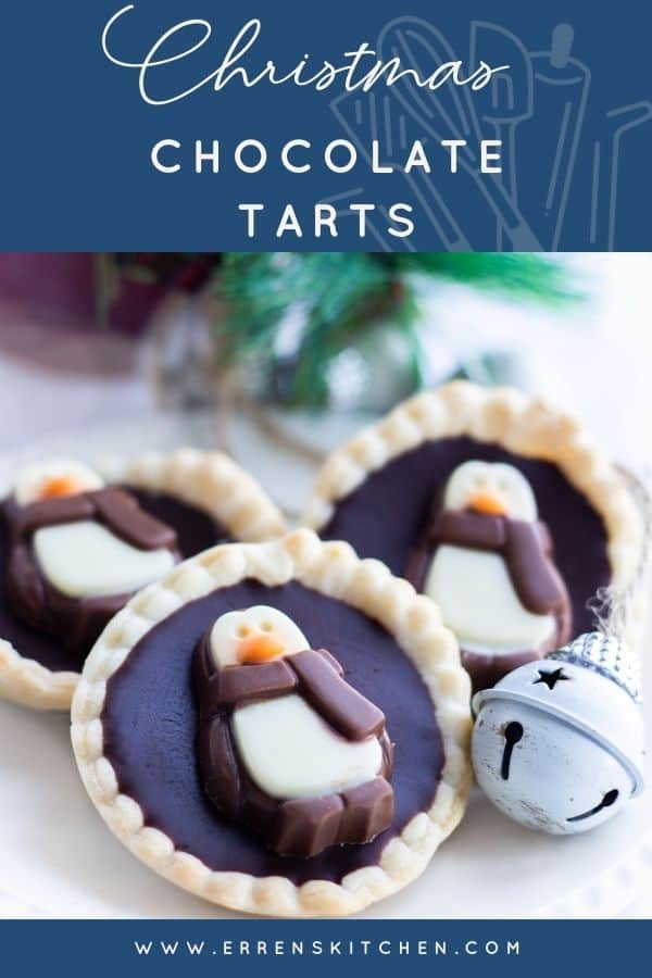 Three chcolate tarts on a plate with christmas decorations