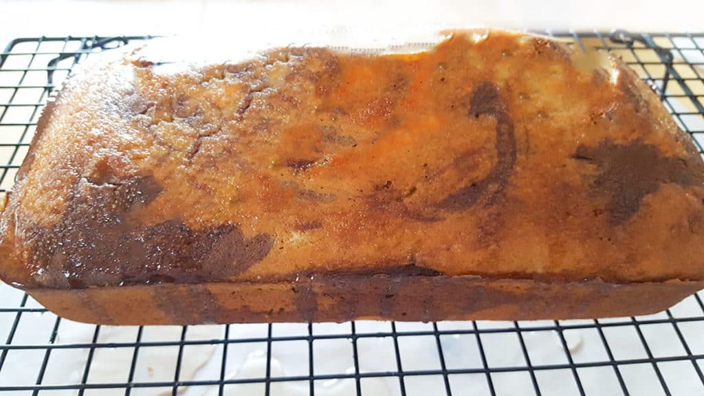 The cooked marble cake on a wire rack ready to be glazed