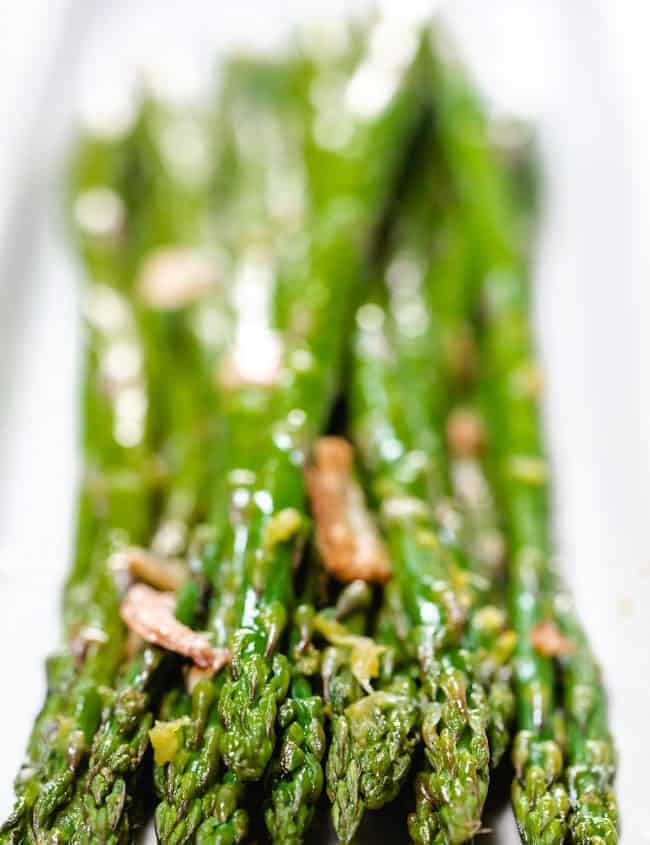 a close up of roasted aspargus on a plate