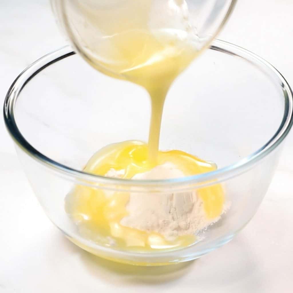 flour mixture being poured into a bowl