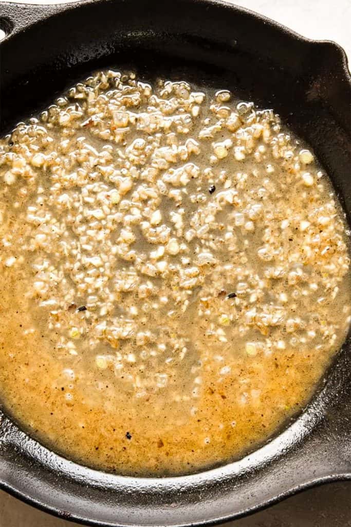 Garlic and white wine in a pan