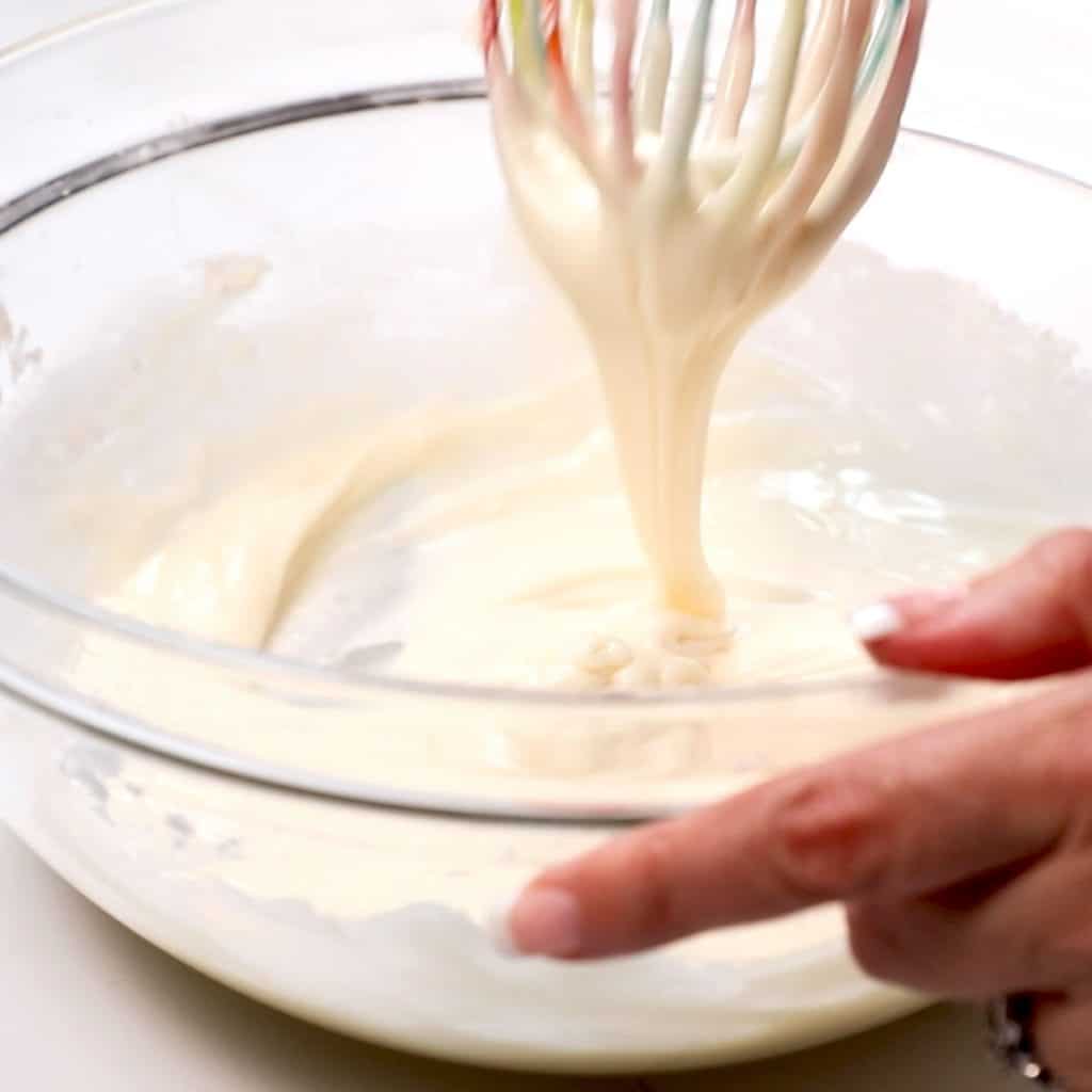 the icing being mixed with a whisk