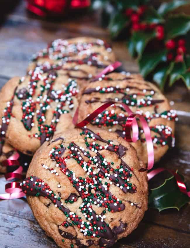 a stack of chocolate chip cookies decorated with christmas sprinkles