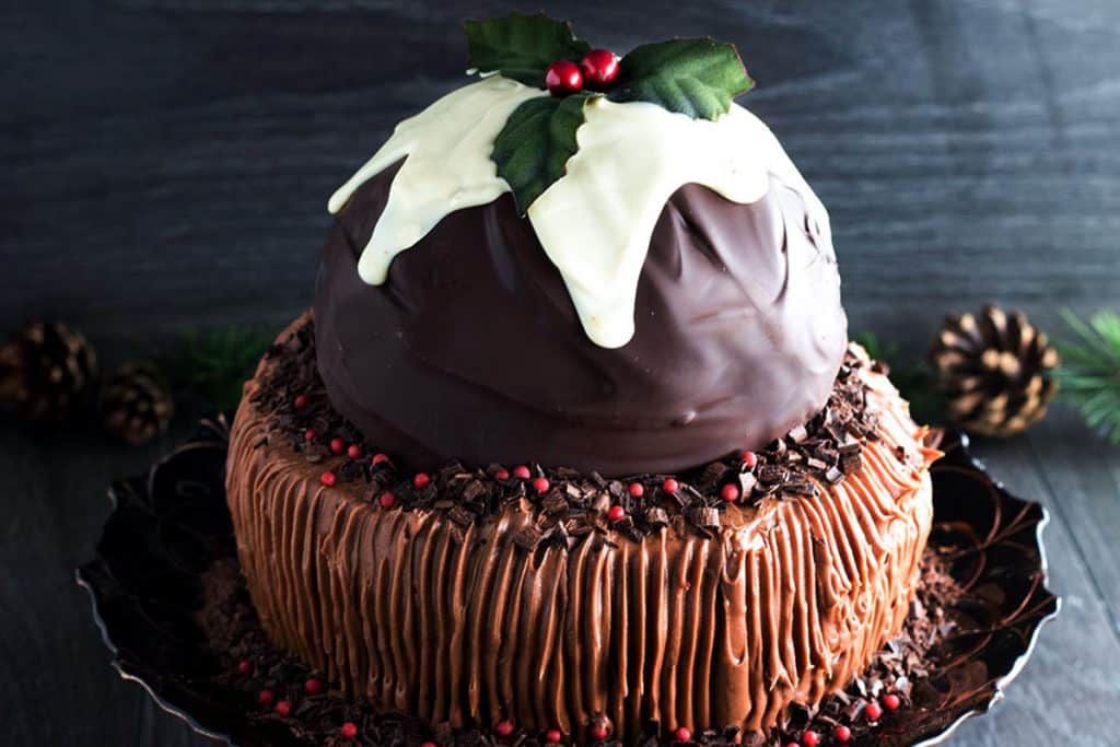 a chocolate cake topped with a christmas pudding made out of chocolate