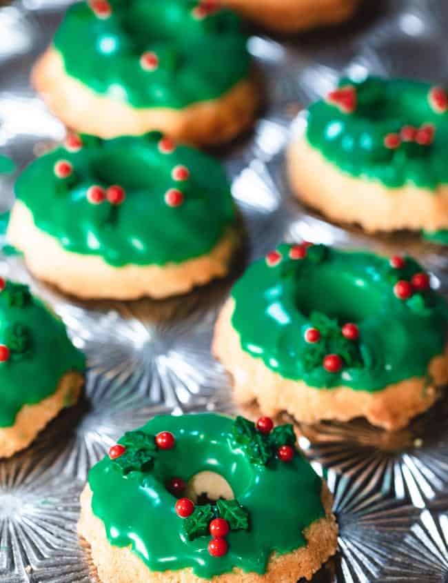 two rows of Christmas Wreath Cookies on a silver baking tray