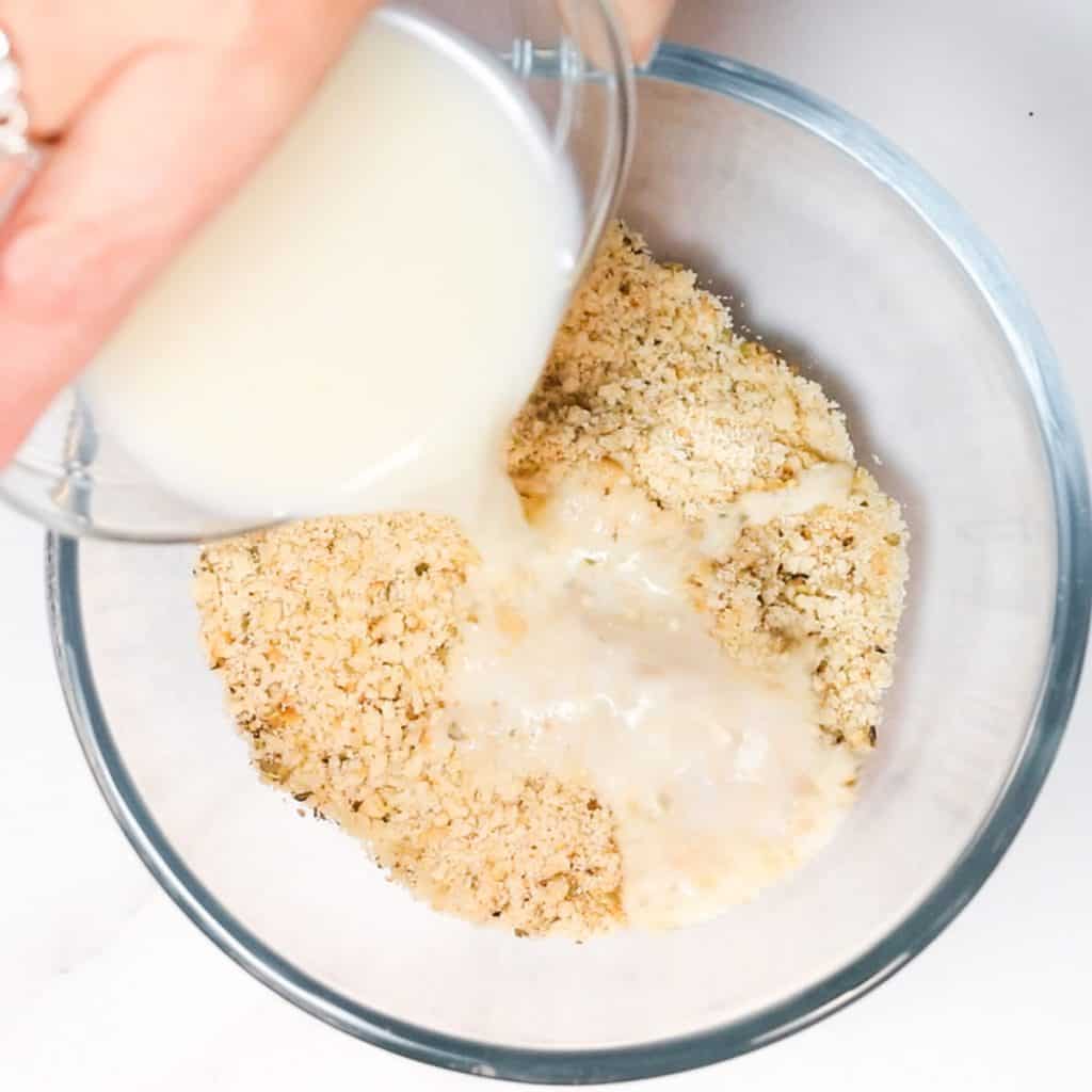 milk being poured into breadcrumbs