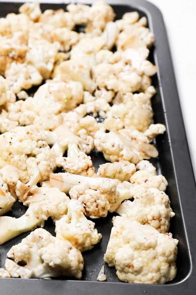cauliflower spread evenly on a baking sheet.