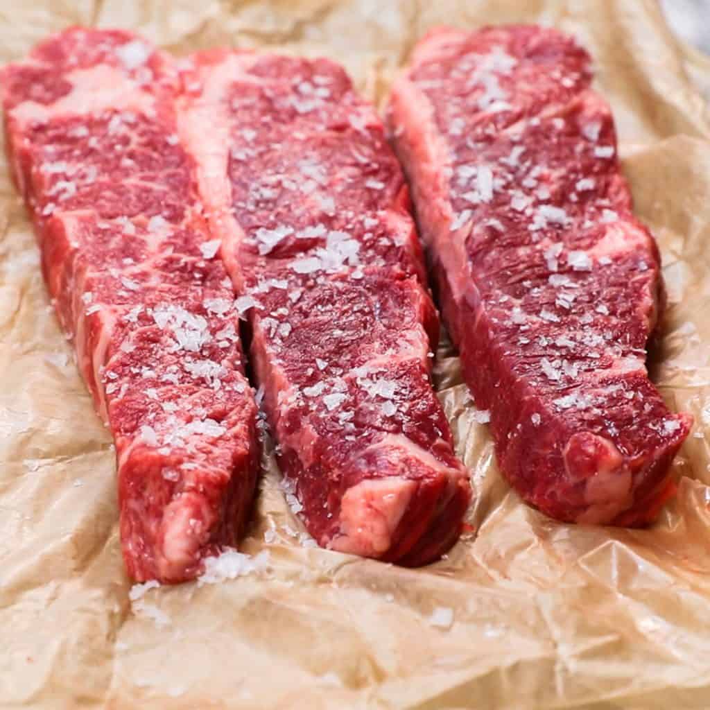 salted raw short ribs on butcher paper