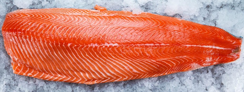 a piece of raw salmon on ice